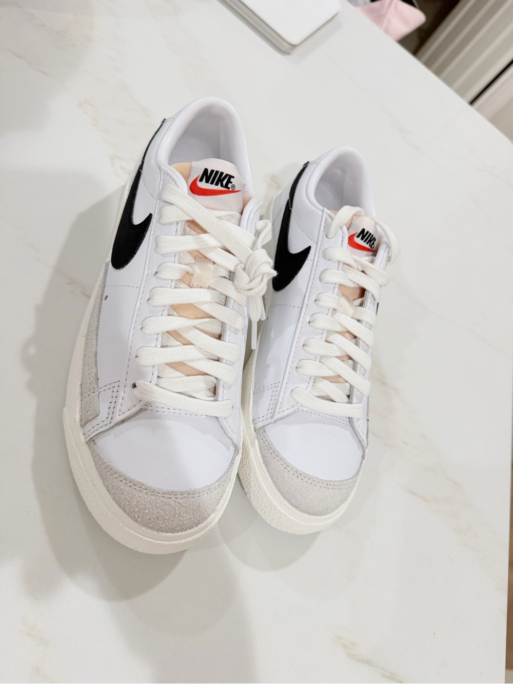 Nike White Low-Top Sneakers with Black Swoosh